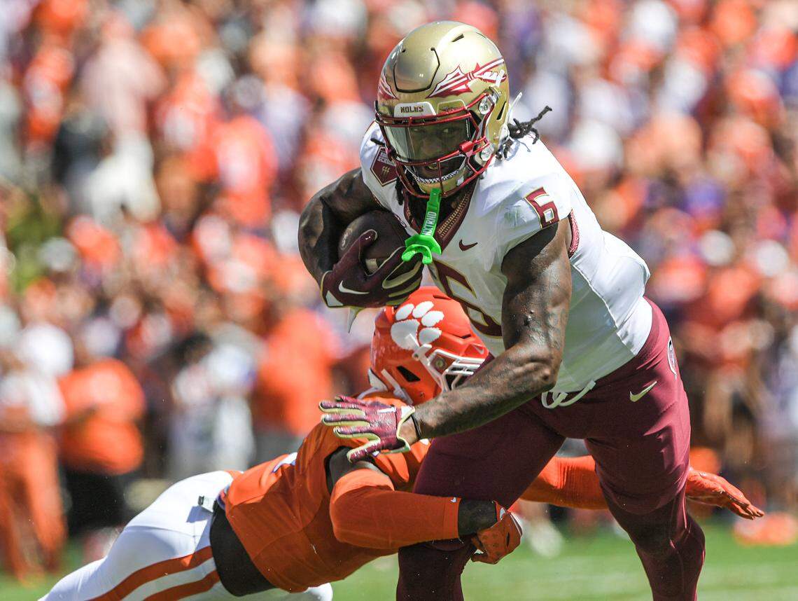 Sep 23, 2023; Clemson, South Carolina, USA; Florida State Seminoles tight end Jaheim Bell (6) runs against Clemson Tigers safety Andrew Mukuba (1) during the second quarter at Memorial Stadium. Mandatory Credit: Ken Ruinard-USA TODAY Sports