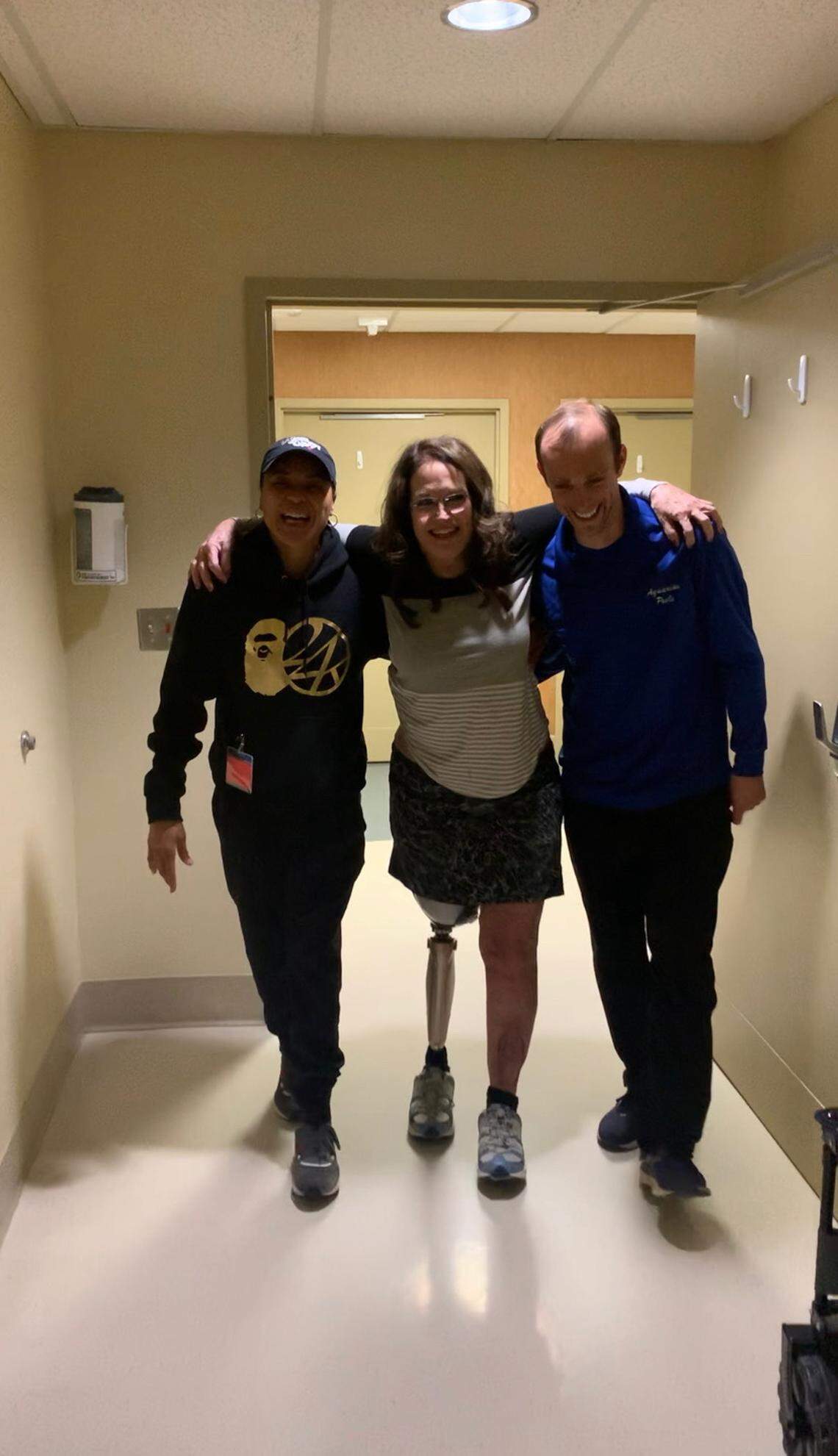 USC women’s basketball coach Dawn Staley, left, goes for a walk with Shawn Kiser, center.
