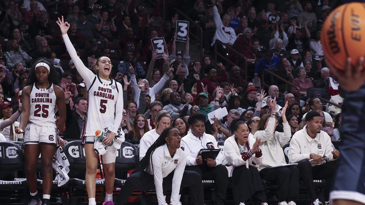 South Carolina's Tessa Johnson (5) and Raven Johnson (25) celebrate a three-point shot during the second half of action of their women's basketball game against Penn State at Colonial Life Arena on Sunday, Dec. 14, 2025.