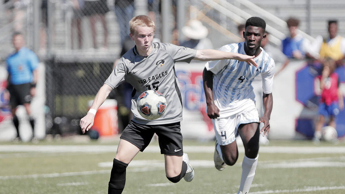 Gray Collegiate’s Ben Richards battles for the ball against Christ Church during the 2022 Class 2A boys soccer state championship match Saturday, held at Irmo High School.