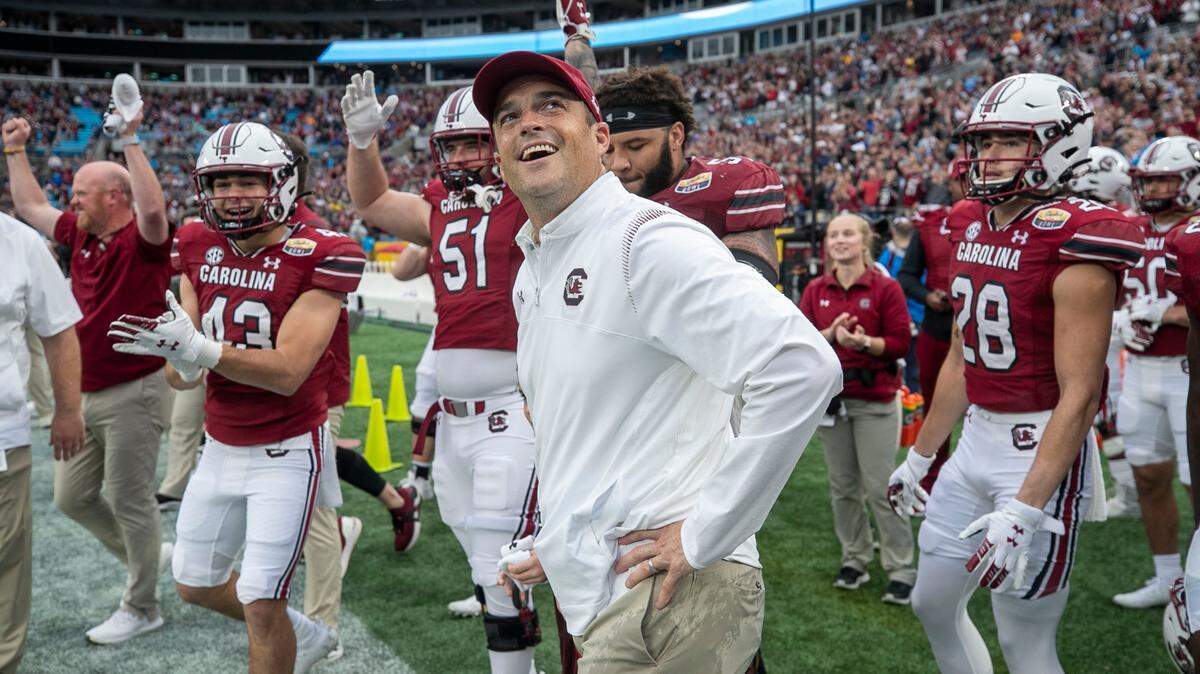South Carolina coach Shane Beamer watches as the final seconds of the game clock run down and the Gamecocks’ celebrate their 38-21 victory over North Carolina on Thursday, December 30, 2021 at Bank of America Stadium in Charlotte, N.C.
