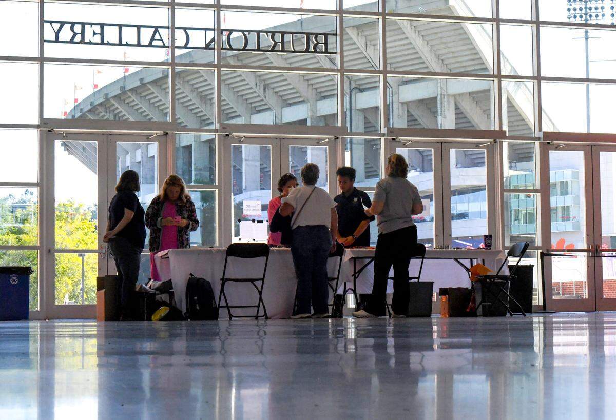 Visitors inside within view of Clemson’s Memorial Stadium, stopping at booths during the One Stop Shop, Team SC County Day at Littlejohn Coliseum in Clemson, S.C. Wednesday, October 9, 2024.