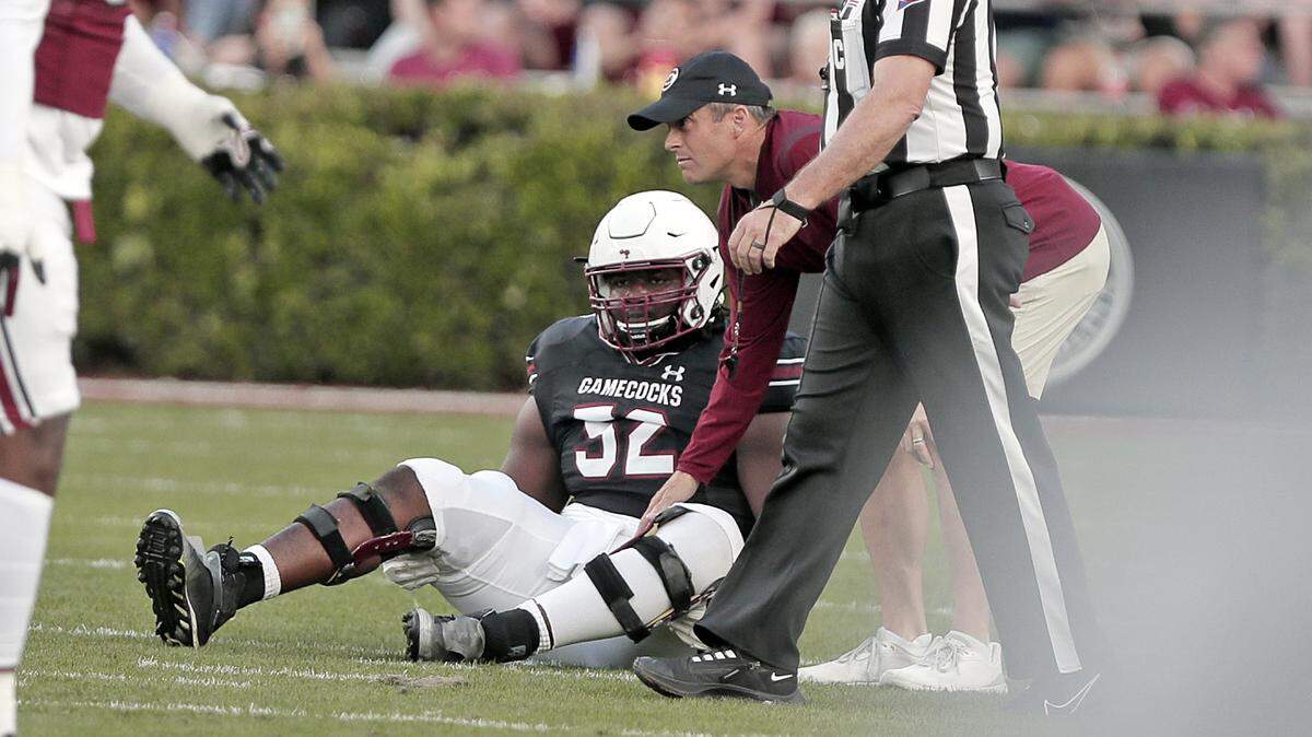 Shane Beamer tends to Jaylen Nichols after the offensive lineman was injured in the 2023 spring game.