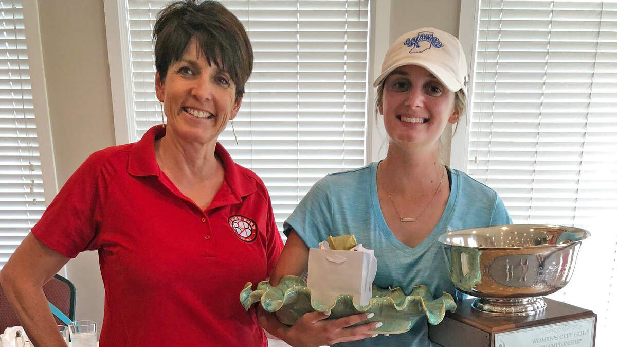 Sonic Columbia City Women’s Golf Championship winner Madison Branum, right, stands Tuesday with Sutton Shaw, executive director of the Big Red Barn Retreat, the tournament’s charity.