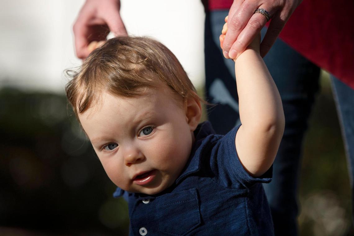 Alice Phillips and Bryce Bancroft pose for a portrait with their son Hugo Bancroft at their home on Thursday, February 25, 2021. Hugo was born shortly before measures to prevent the spread of the coronavirus were put into place, so has had limited interactions with the outside world.