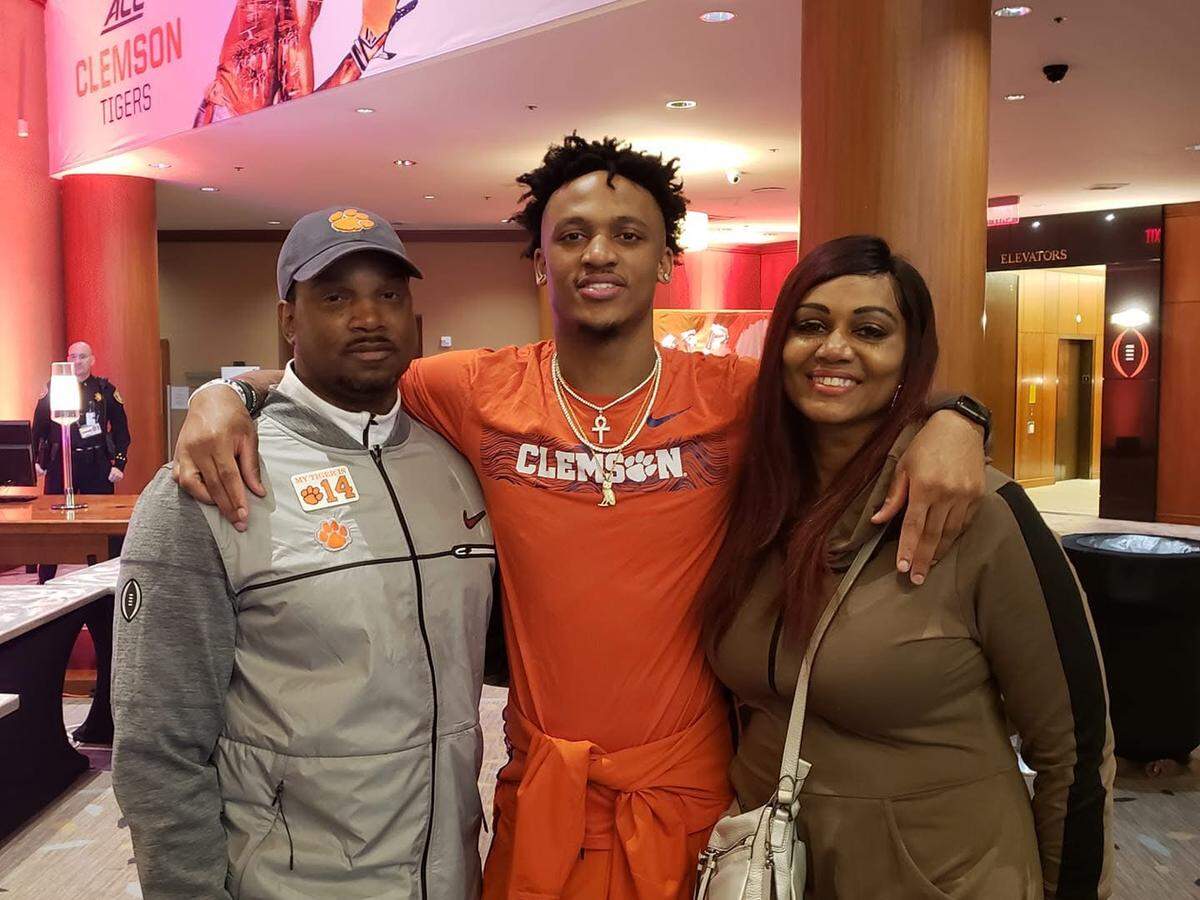 Diondre Overton (middle) poses for a picture with his mother Sandra Grace (right) and his stepfather Bryan Hill (left).