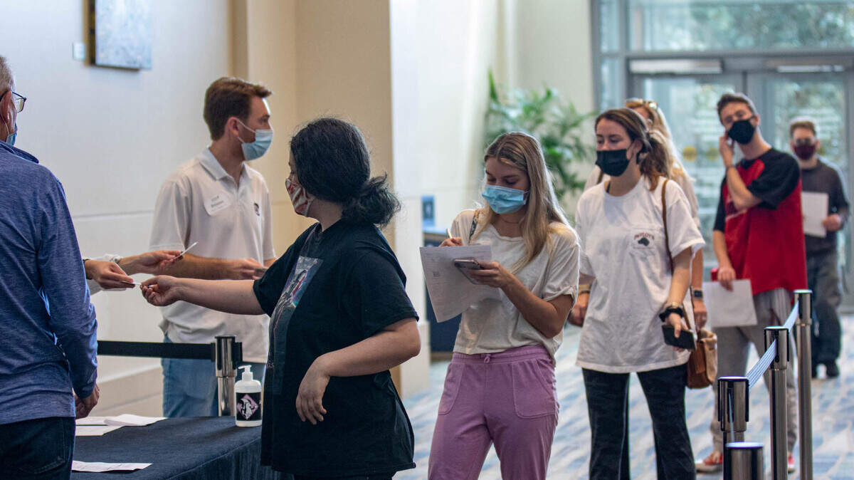 Hospitality workers file into the Columbia Convention Center during a vaccination clinic. The South Carolina Restaurant and Lodging Association partnered with Loveless Family Medicine to provide about 400 vaccines at the Columbia Convention Center.