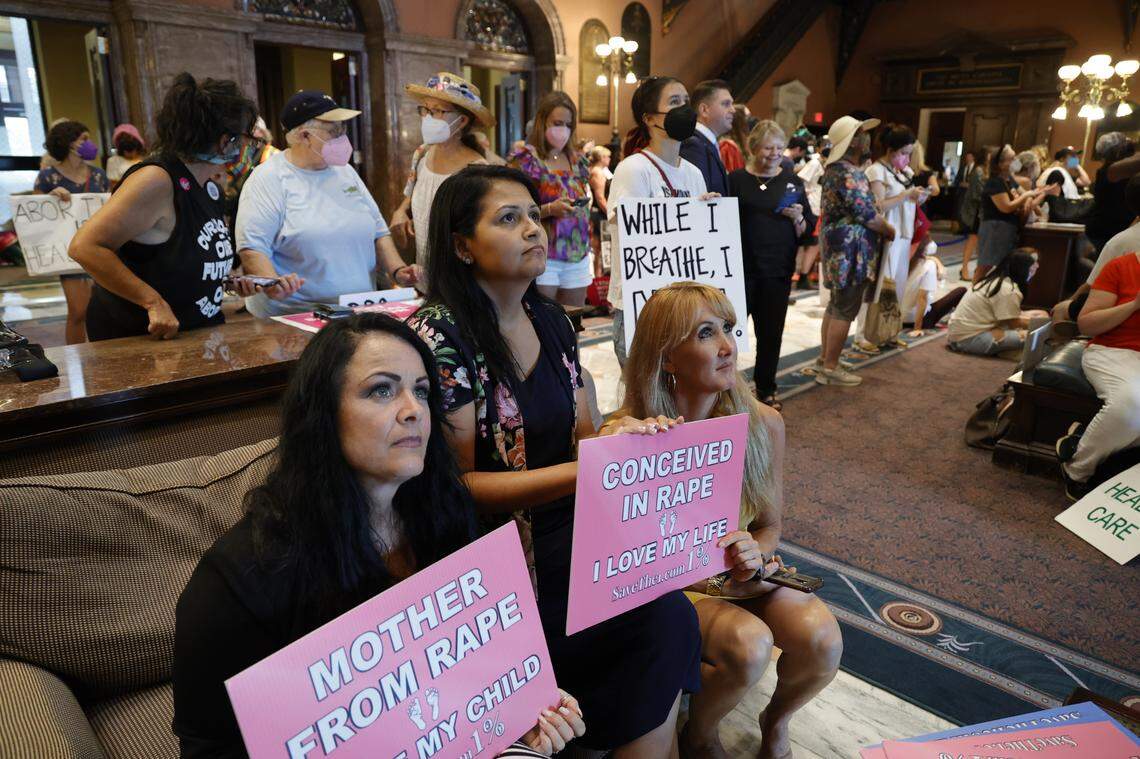 Sharon Annichino, Tammy Kale and Rebecca Kissling watch from the state house lobby as the South Carolina House of Representatives debates amendments on the abortion ban bill on Tuesday, Aug. 30, 2022.
