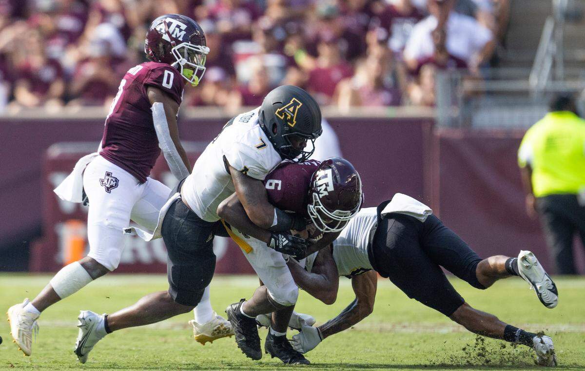 Sep 10, 2022; College Station, Texas, USA; Texas A&M Aggies running back Devon Achane (6) is tackled by Appalachian State Mountaineers linebacker Trey Cobb (7) in the second half at Kyle Field.