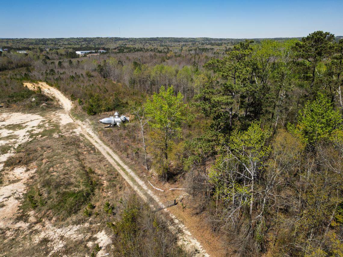 Busted Plug, a sculpture by Columbia artist Blue Sky, lies in a field north of Columbia on Wednesday, March 26, 2025. The 40-foot sculpture was installed in downtown Columbia until 2023.