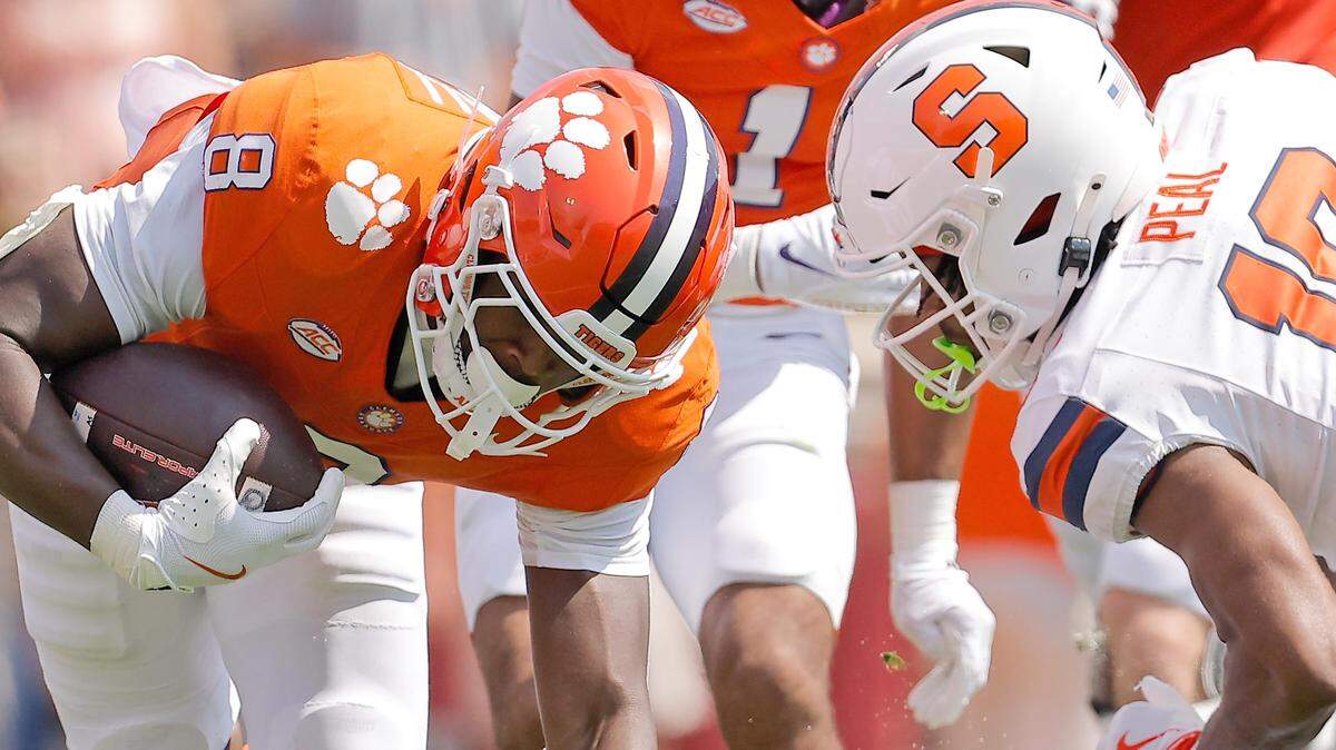 Clemson running back Adam Randall (8) is tripped up by Syracuse defensive back Cornell Perry (19) during first-half action in Clemson, S.C on Saturday, Sept. 20, 2025.