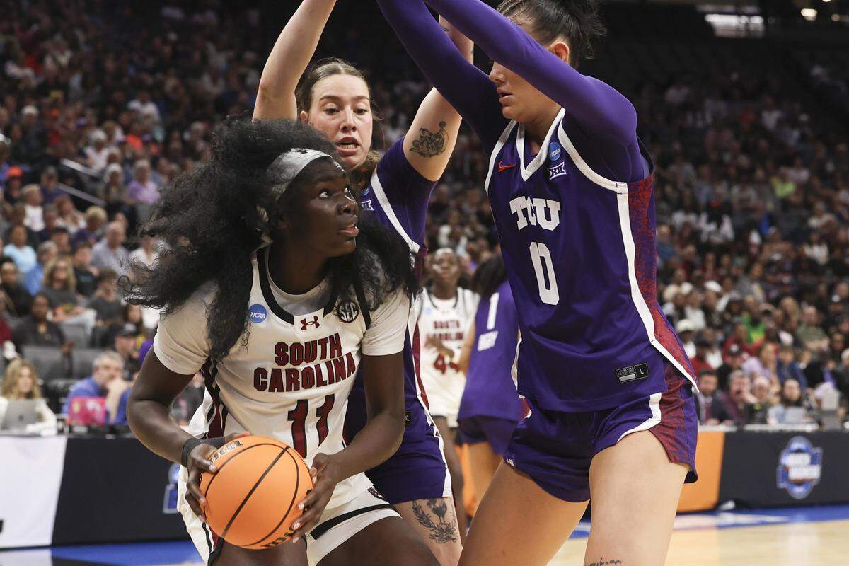 South Carolina's Madina Okot (11) looks to shoot as TCU’s Marta Suarez (7) and Kennedy Basham (0) defend during the first half of action of their Elite Eight women's basketball game against TCU at Golden 1 Arena on Monday, March 30, 2026.