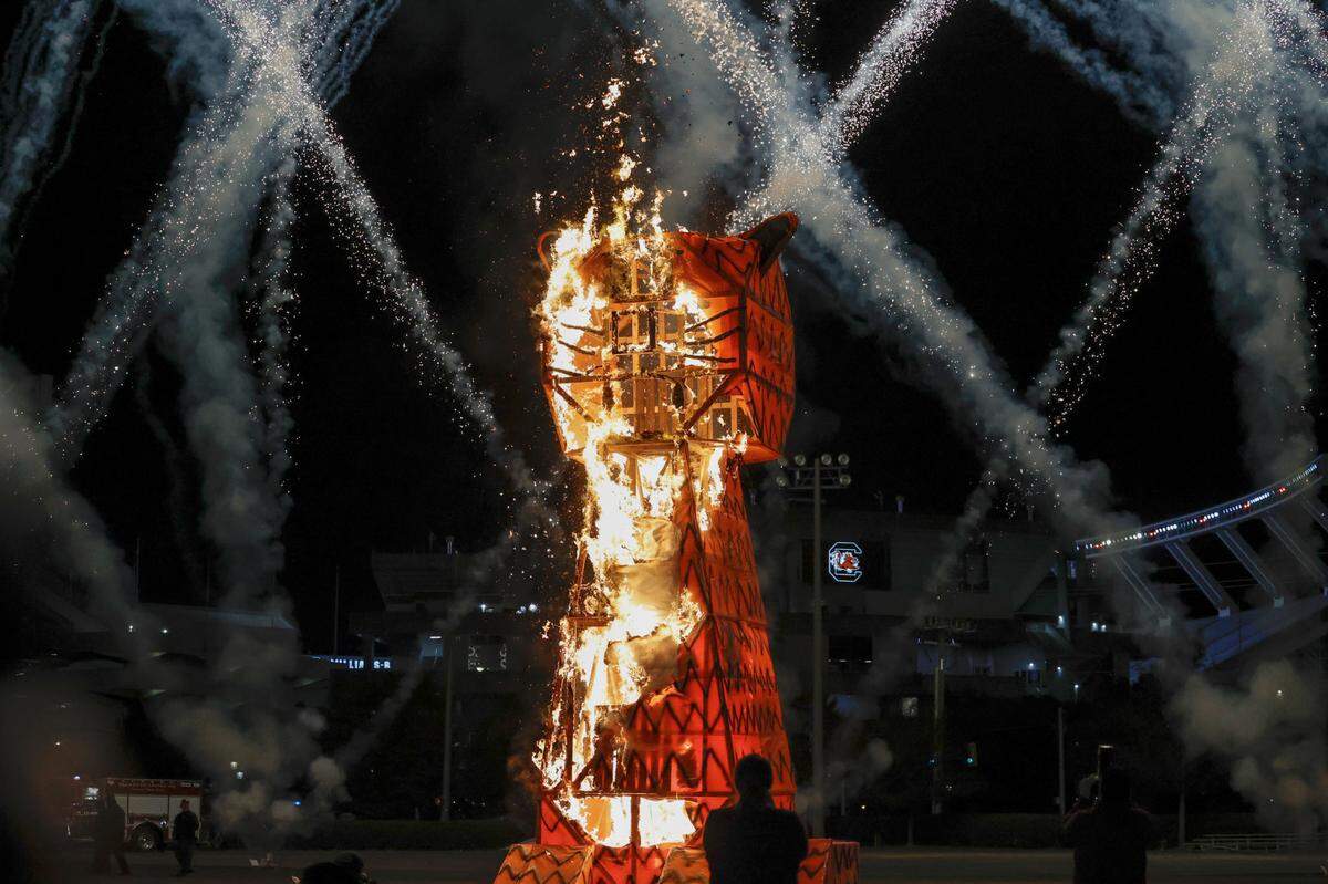 The 20-foot-tall Clemson Tiger goes up in flames during the annual Tiger Burn at the University of South Carolina intramural fields on Monday, Nov. 21, 2022, at Charleston Southern University. Students from the American Society of Mechanical Engineers constructed the tiger effigy.