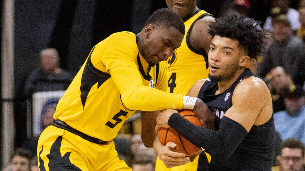 South Carolina’s Jacobi Wright, right, has the ball taken from him by Missouri’s D’Moi Hodge, left, as Kobe Brown, center, looks on during the first half of an NCAA college basketball game Tuesday, Feb. 7, 2023, in Columbia, Mo. (AP Photo/L.G. Patterson)