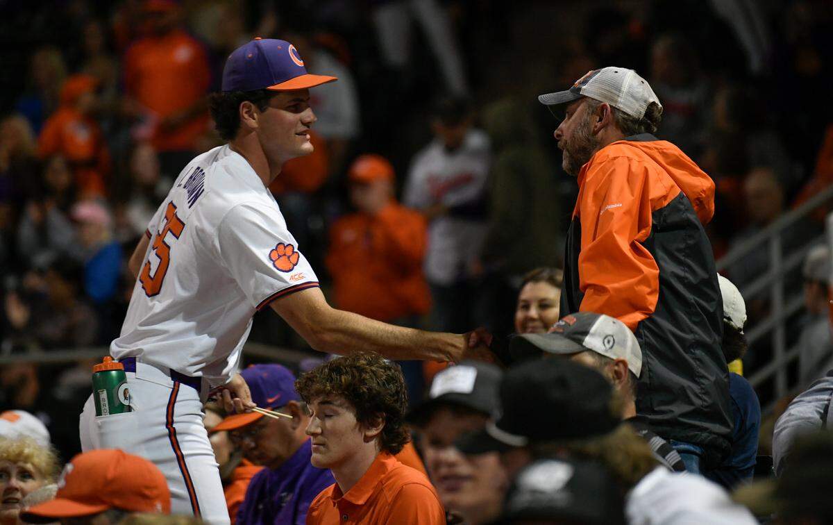 Clemson pitcher Luke Brown (25) shakes hands with Air Force veteran Jeff Williams of Six Mile between innings of the Tiger’s baseball game against Georgia Tuesday, April 22, 2025, at Clemson’s Doug Kingsmore Stadium.