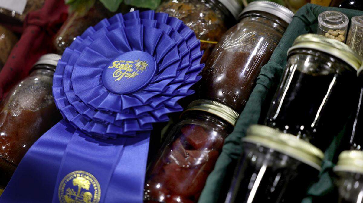 A local farm display wins a blue ribbon for its variety of high quality farm-produced foods including home canned items. Visitors can also find fresh honey, Christmas trees and over 100-pound pumpkins in the agricultural building at the State Fair.