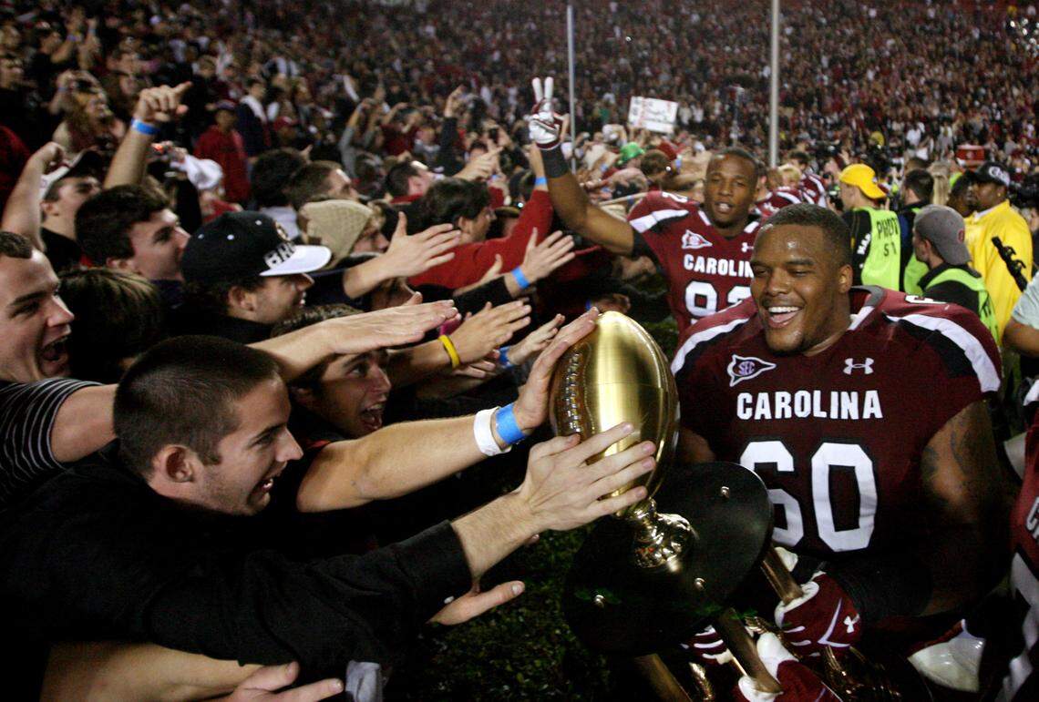 South Carolina Gamecocks guard Terrence Campbell (60) celebrates their win over Clemson with fans at Williams-Brice Stadium, Saturday, November 26, 2011.