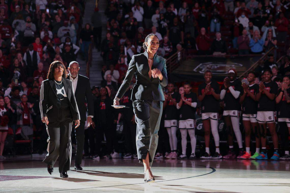 A’ja Wilson walks out at the Colonial Life Arena with her parents, Eva and Roscoe Wilson during a ceremony to retire her jersey and hang it in the Colonial Life Arena on Sunday, Feb. 2, 2025.