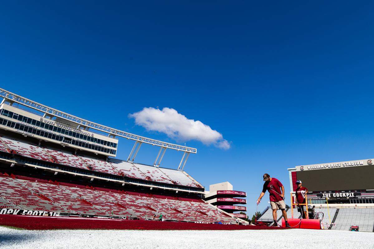 Workers at the University of South Carolina paint the field at Williams-Brice Stadium on Friday, September 12, 2025.