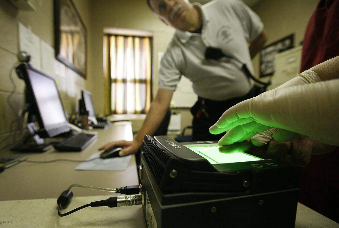 A Lexington County Detention Center officer checks scans of fingerprints in 2011 Lexington County Detention Center checks the immigration status of everyone booked at the jail.