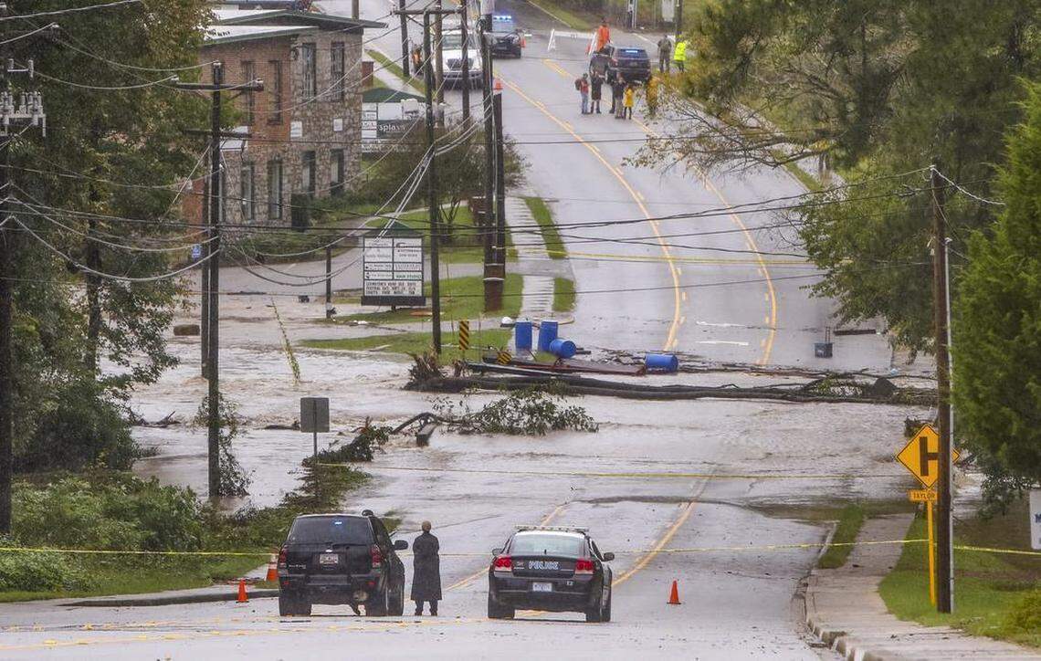 A portion of Main street in Lexington was closed off after flood waters in Twelvemile Creek broke through the Old Mill dam in Lexington on Oct. 4, 2015.