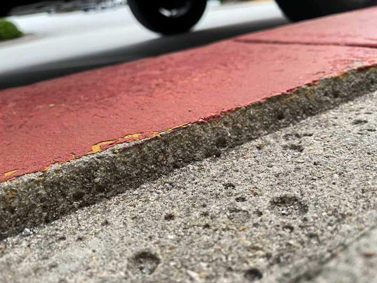 A channel or gap — about 3 inches wide and a half inch deep — lies between the sidewalk and curb in front of the Lexington County Auxiliary Administrative building.