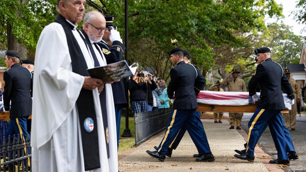 Prayers are read as fourteen American and British soldiers who died fighting the in American Revolution are unloaded in Camden, South Carolina on Saturday, April 22, 2023.