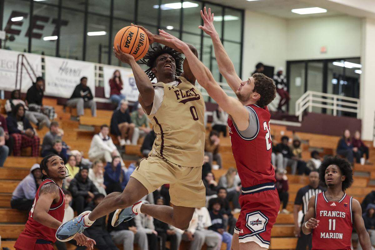 Erskine College’s Anthony Phillips, Jr. goes up for a shot as Francis Marion’s Clyde Mauldin defends on Wednesday, Jan. 21, 2026.