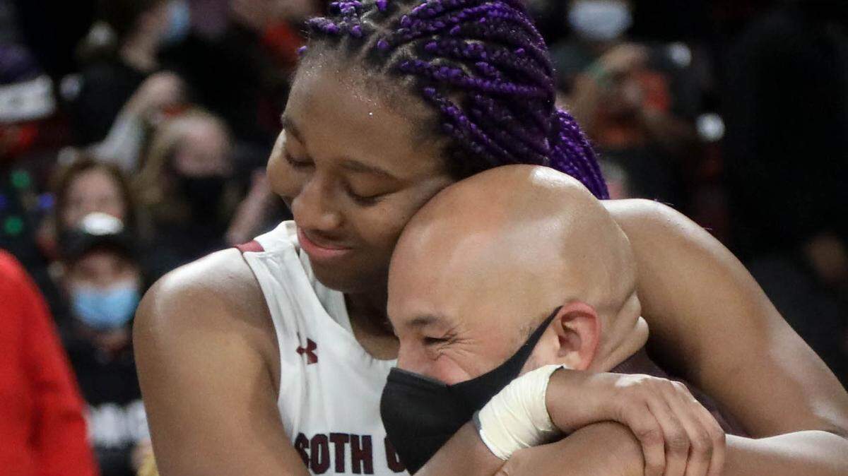 South Carolina’s Aliyah Boston (4) embraces University of South Carolina Assistant Coach Fred Chmiel after the Gamecocks played Maryland on Sunday, Dec. 12, 2021 in the Colonial Life Arena. Carolina won, 66-59.