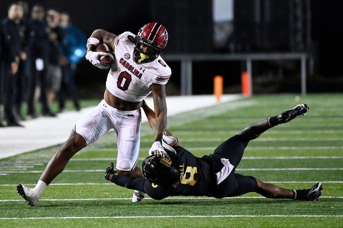 South Carolina running back Jaheim Bell (0) runs past Vanderbilt cornerback Tyson Russell (8) in the first half of an NCAA college football game Saturday, Nov. 5, 2022, in Nashville, Tenn. (AP Photo/Mark Zaleski)