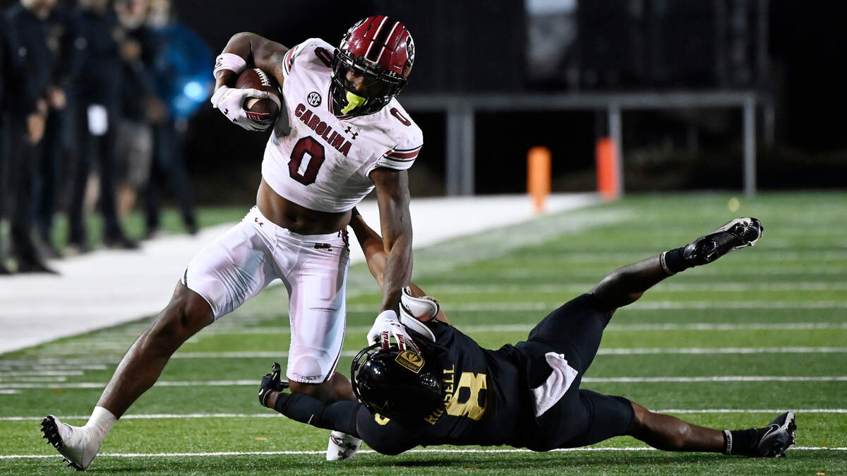 South Carolina running back Jaheim Bell (0) runs past Vanderbilt cornerback Tyson Russell (8) in the first half of an NCAA college football game Saturday, Nov. 5, 2022, in Nashville, Tenn. (AP Photo/Mark Zaleski)