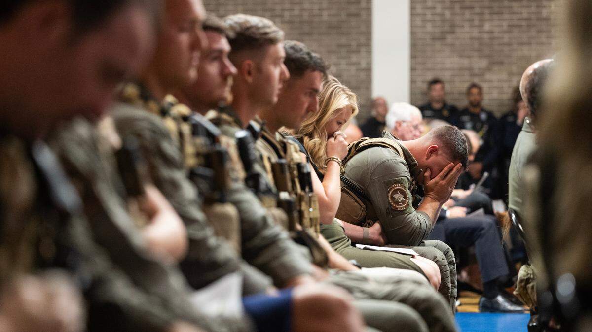 State Law Enforcement Division SWAT agents cry during a funeral for police K-9 Rico, who was killed last week while tracking a suspect. SLED agents who spoke at the funeral say Rico’s actions saved the lives of several human officers.