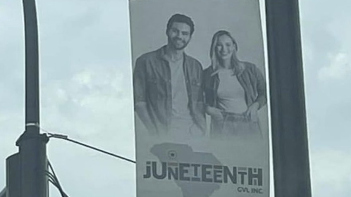 This banner on Greenville’s Main Street has raised questions about showing a white couple to celebrate a federal holiday commemorating the freeing enslaved Americans. 
