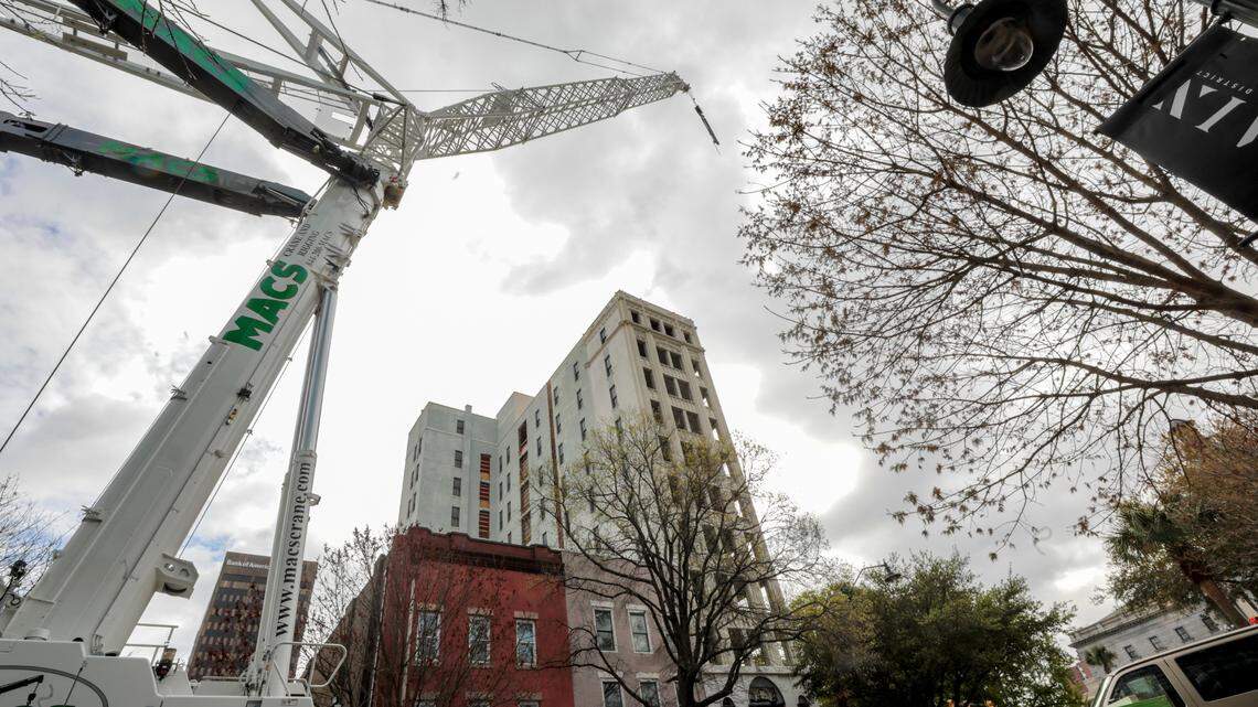 A crane sits on the 1200 block of Columbia’s Main Street on Tuesday, March 22, 2023, where a historic building is being converted into a Moxy hotel.