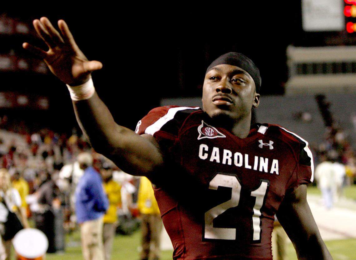 USC running back Marcus Lattimore waves to fans while leaving the field at Saturday's football game against Navy in 2011.