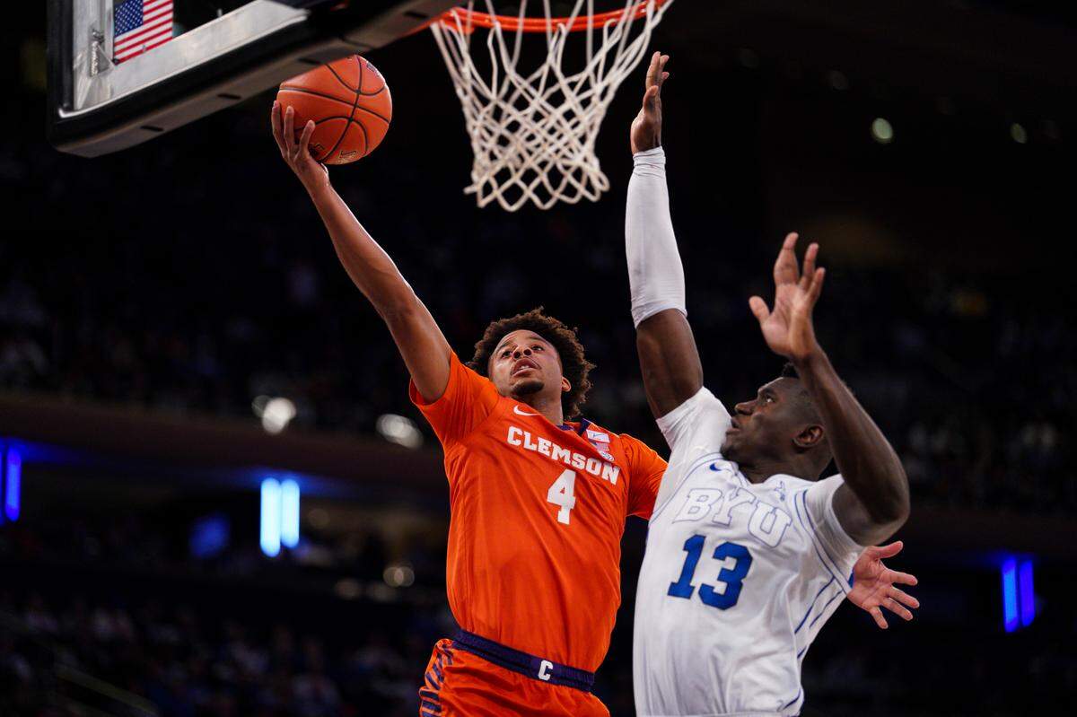 NEW YORK, NEW YORK - DECEMBER 09: Butta Johnson #4 of the Clemson Tigers goes to the basket against Keba Keita #13 of the BYU Cougars in the second half at Madison Square Garden on December 09, 2025 in New York City.