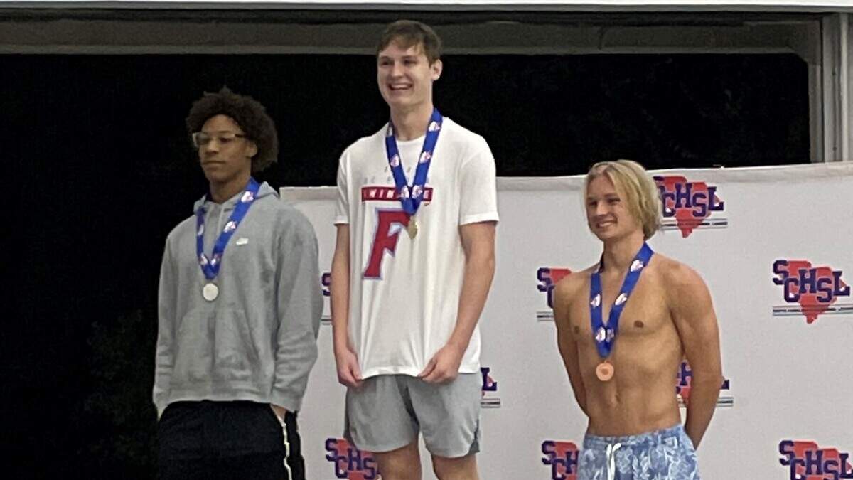 AC Flora’s Darden Tate, middle, won two individual championships at the 2022 SC high school swimming championships on Oct. 7-8.