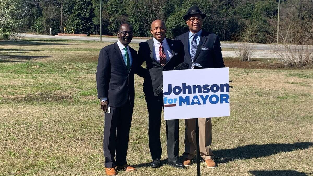 Councilmen Sam Davis (left) and Ed McDowell (far right) endorse Sam Johnson for Columbia mayor March 8.