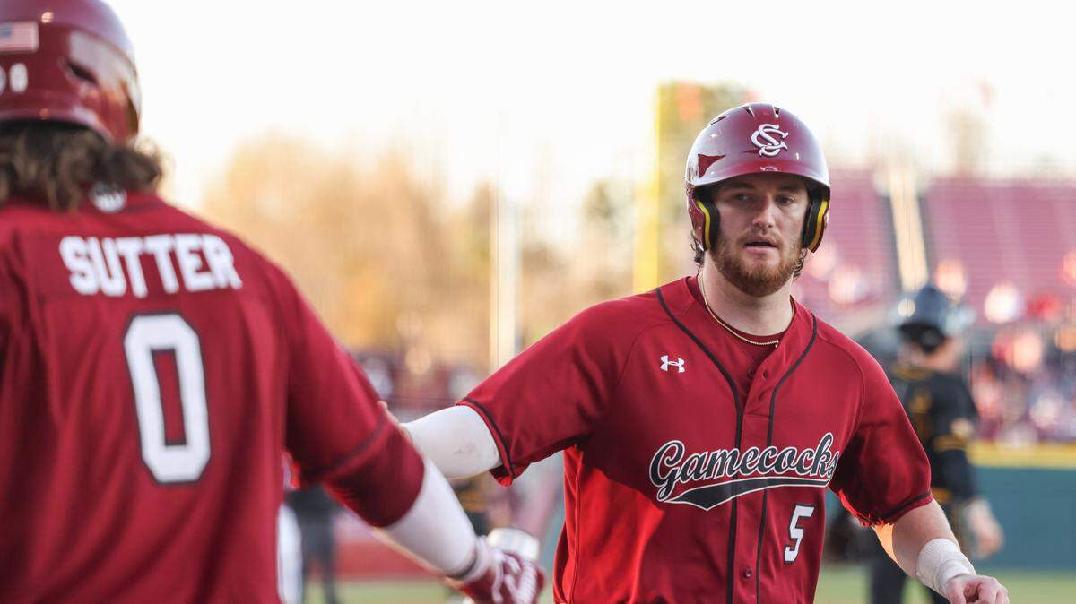South Carolina catcher Talmadge LeCroy (5) is congratulated by infielder Logan Sutter (0) after scoring during the second game of South Carolina’s doubleheader against Northern Kentucky in Columbia on Friday, February 13, 2026.
