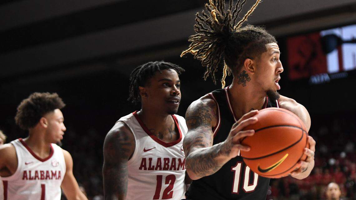 South Carolina guard Myles Stute (10) grabs a rebound defended by Alabama guard Mark Sears (1) and guard Latrell Wrightsell Jr. (12) during the game at Coleman Coliseum.