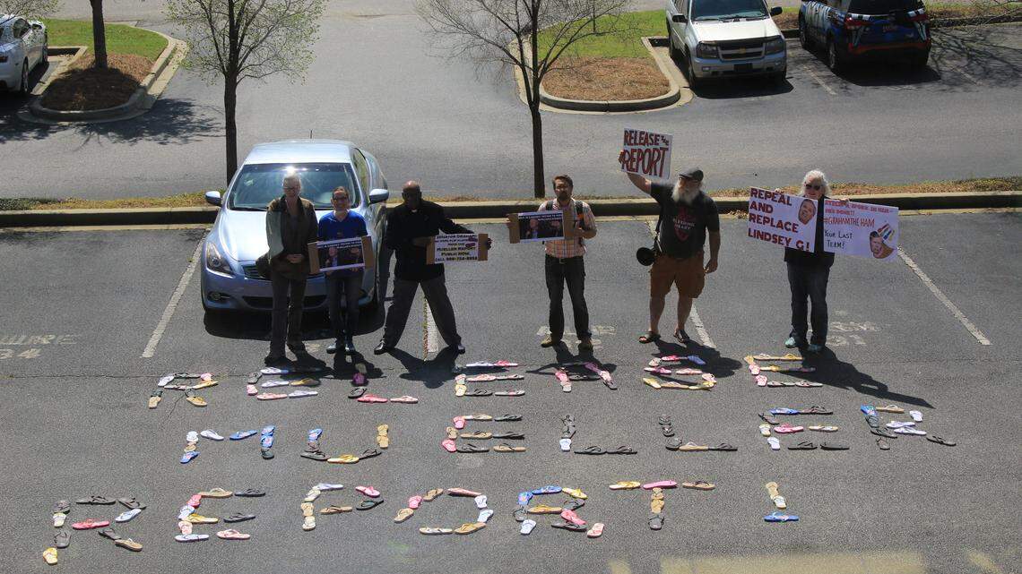 Protesters gather outside of the Columbia office of U.S. Sen. Lindsey Graham, leaving a message in flip flops.
