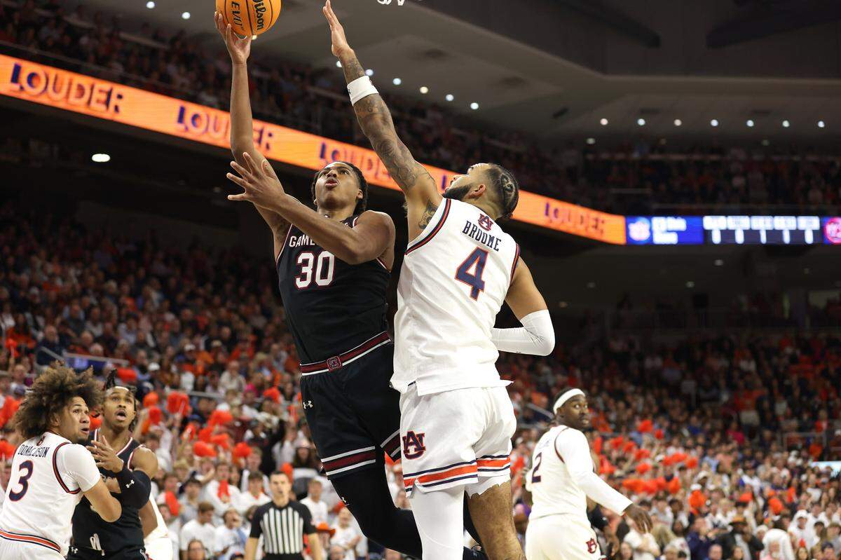Feb 14, 2024; Auburn, Alabama, USA; South Carolina Gamecocks forward Collin Murray-Boyles (30) takes a shot as Auburn Tigers forward Johni Broome (4) defends during the first half at Neville Arena. Mandatory Credit: John Reed-USA TODAY Sports
