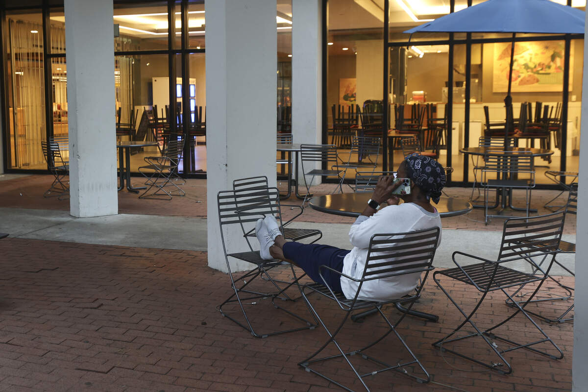 Dorothy Ham-Kisteneff sits outside the USC Campus Store at the Russell House before it opens at 7 a.m. on Wednesday, July 1, 2026. Ham-Kisteneff was first in line to buy Nike logo Gamecock apparel for her son and family.
