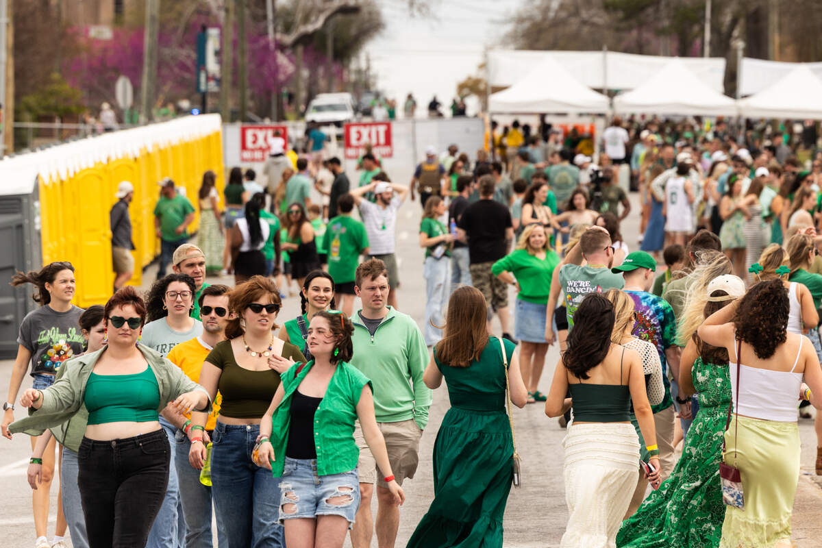 People enter the Devine Street gate of the St. Pat’s in Five Points festival in Columbia, South Carolina on Saturday, March 15, 2025.