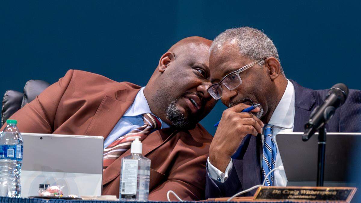 Dr. Aaron Bishop, Chairman of the Richland One school board, left, talks with Superintendent Dr. Craig Witherspoon during a meeting of the Richland District One school board on Tuesday, Jan. 23, 2024