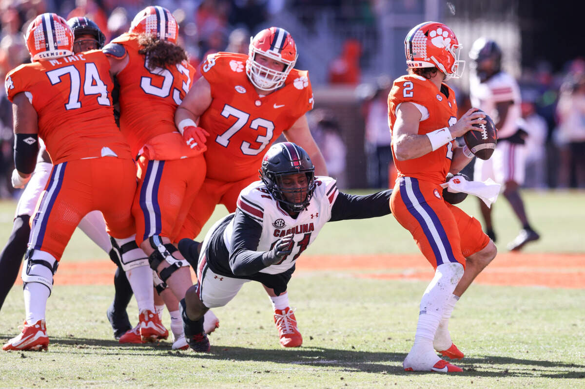 South Carolina defensive tackle Tonka Hemingway (91) tries to bring down Clemson quarterback Cade Klubnik (2) during the Palmetto Bowl between at Memorial Stadium in Clemson on Saturday, November 30, 2024.