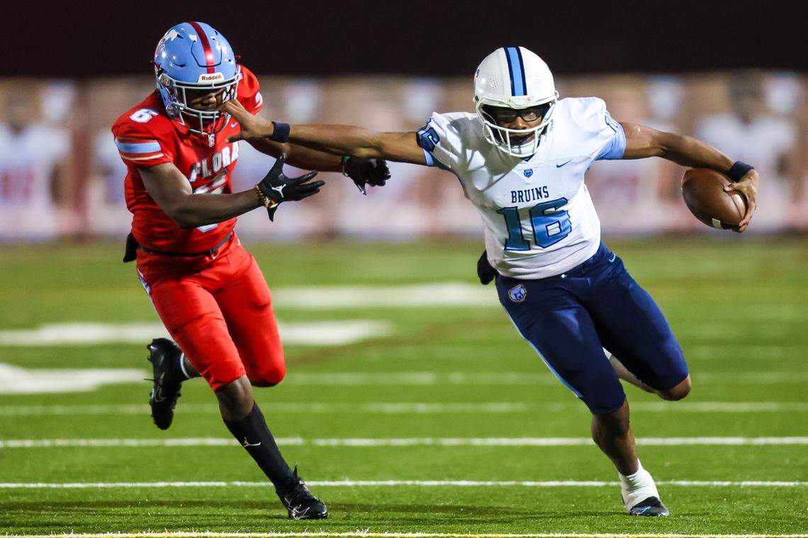 South Florence Lanorris Sellers (16) stiff arms AC Flora Falcons middle linebacker John Friday (6) in the 4A Lower State Championship Game at Memorial Stadium, Nov. 25, 2022.