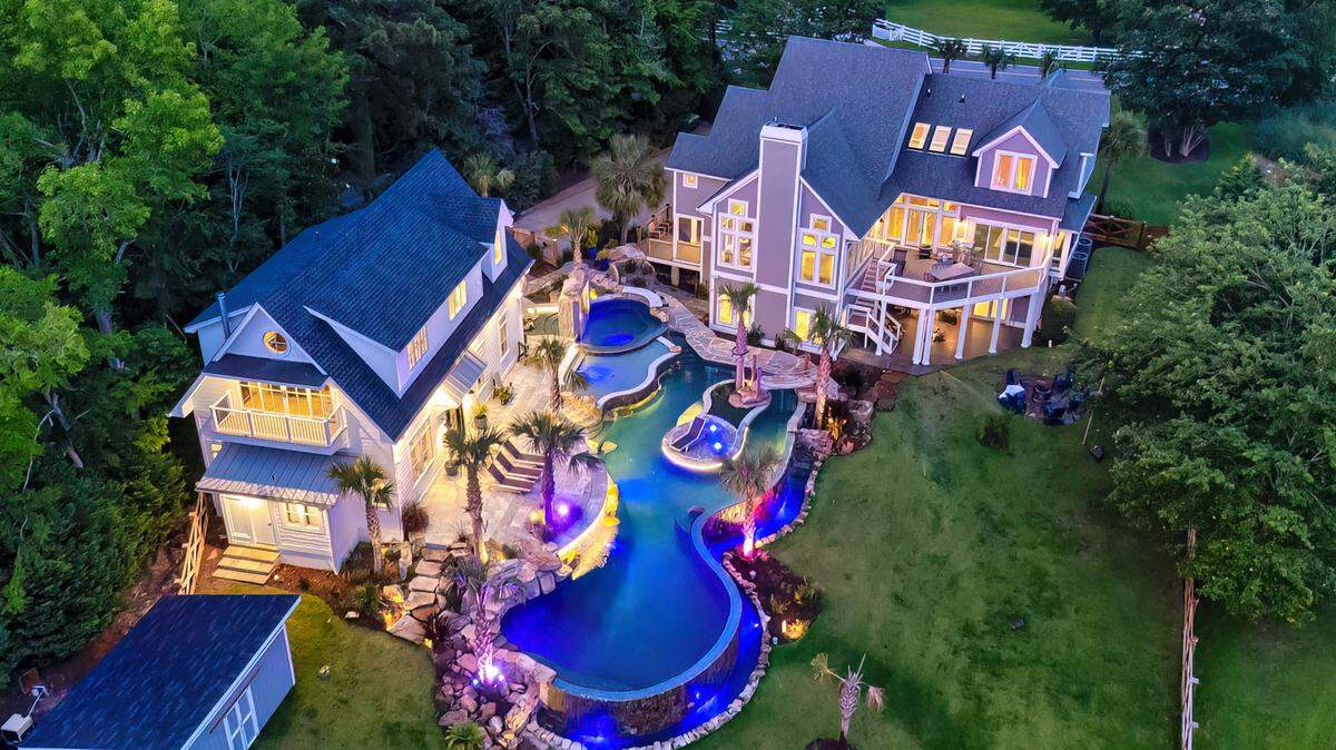 An aerial view of a $3.4 million luxury home by Lake Murray for sale that includes an amazing custom pool.