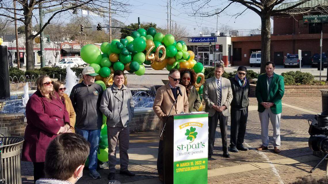 Five Points Association board chairman Steve Cook, center, announces the music lineup for the 2022 St. Pat’s in Five Points festival.