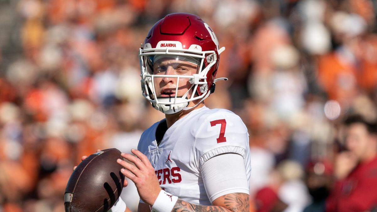 Oklahoma quarterback Spencer Rattler (7) warms up before an NCAA college football game against Texas at the Cotton Bowl, Saturday, Oct. 9, 2021, in Dallas. Oklahoma won 55-48. (AP Photo/Jeffrey McWhorter)